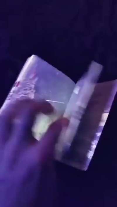 Latvian passport under UV light