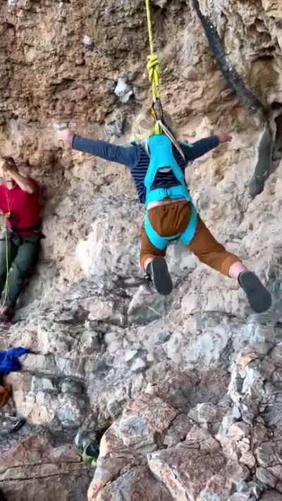 Little kid getting comfortable on a climbing rope