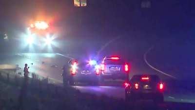 Police blocked off the road for a fatal crash scene. Someone tried to drive through it anyway