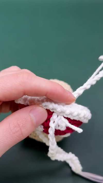 I crocheted a tiny gnome home to use as a dice pouch