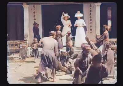 Two Women Throwing Coins in the Street for Poor Children to Pick Up - Vietnam, 1899
