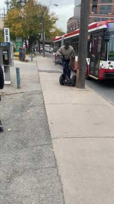 Segway man rescues raccoon from busy road
