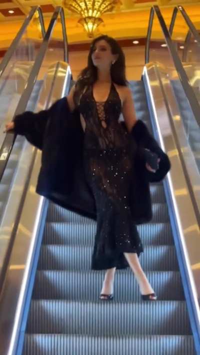 Victoria on the escalator in Vegas, Santa Darlin' | IG | December 2025