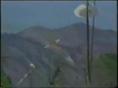 A firefighting C-130 has both its wings ripped off and crashes