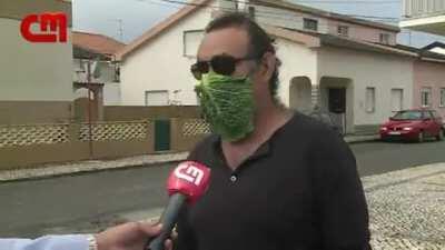 Man giving interview with cabbage mask