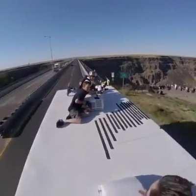 Diving off a bridge from the top of a bus