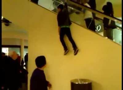 Holding on to the side of an escalator