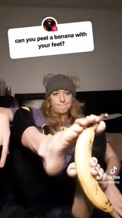 Peeling a banana with her feet