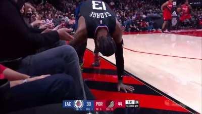 [highlight] Paul George trips over a fan court side, stares at him then asks the ref to look into it