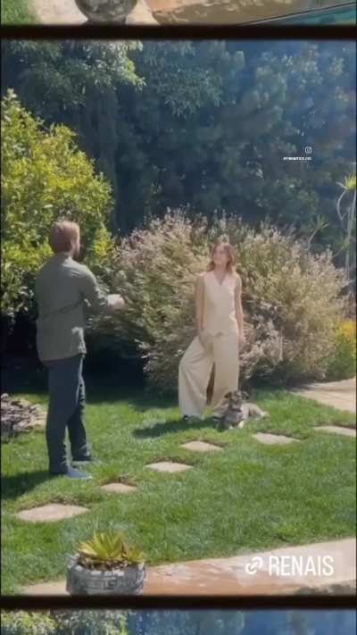 Emma watson. Legs spread  playing with her puppy