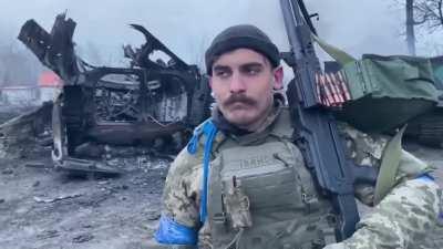 A fighter of the Belarusian battalion shows the destroyed equipment of the Russians