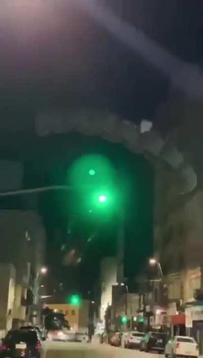 Jumping off a small building with a parachute.