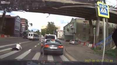 Woman talks on the phone while crossing, gets hit by car.