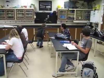 Guy uses stealth in front of his class.