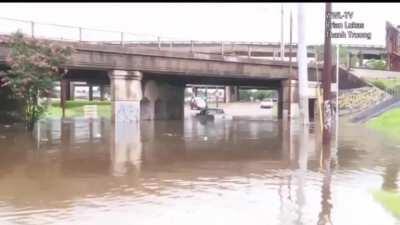Idiot travels around barricades and proceeds to sink truck under flooded bridge