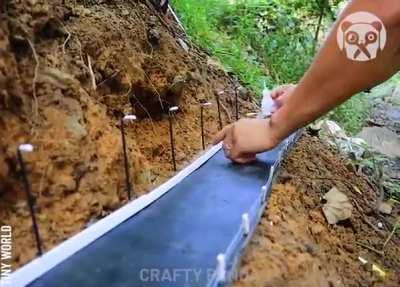Guy building a mini cable wired bridge