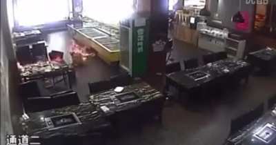 Waitress in China accidentally lights customer on fire