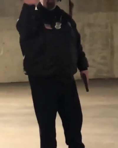 Security Guard points gun at skateboarders.