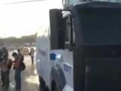Provoking the police who got a truck-mounted water cannon