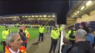Chester vs Wrexham fans after a moment of silence is interrupted.