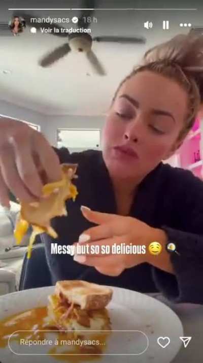 Mandy Rose eating a messy sandwich