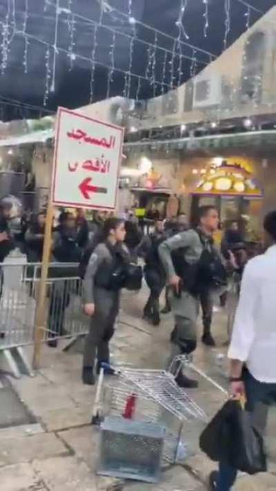 Israeli military terrorizing Palestinian civilians with weapons in Jerusalem market and throwing flash bangs at women and children.