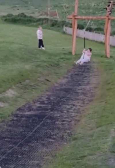 WCGW ridding a zip line intended for children