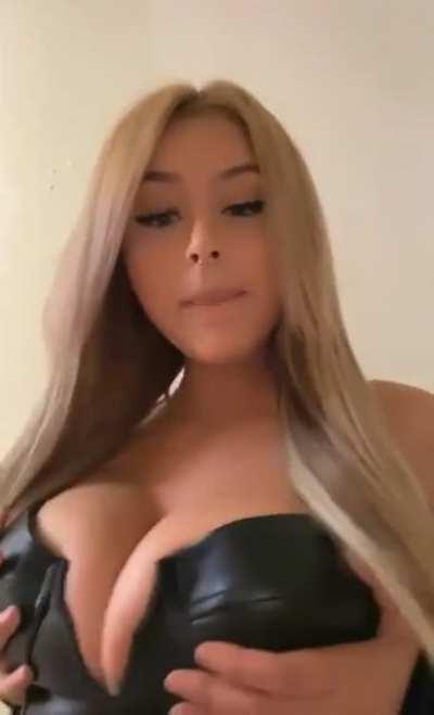 Grabbing her massive tits