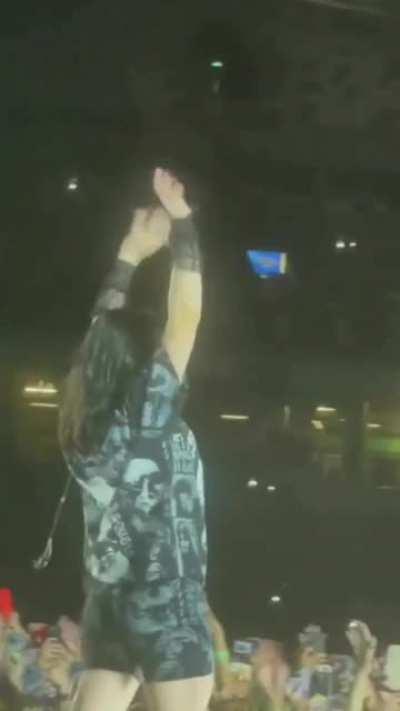 Billie pulling up her leggings on stage