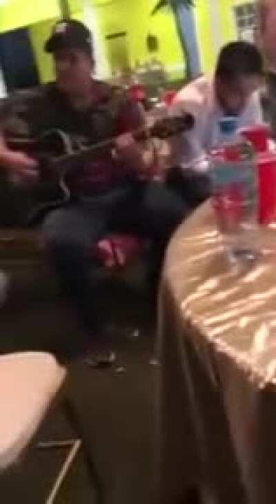 Some sicarios from from sinaloa cartel dressed in military fatigues., also drinking on the job enjoying some live music