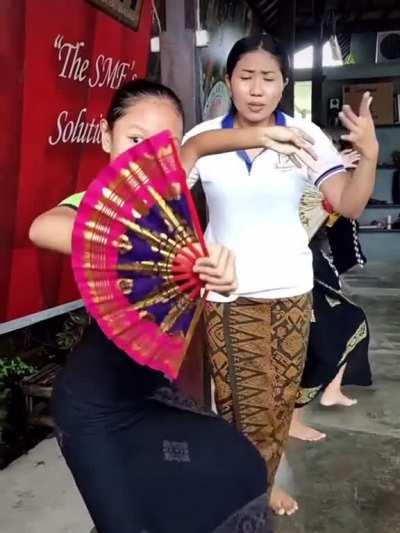 Teacher helping students with choreography.