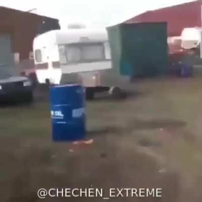 Man puts firework in barrel.