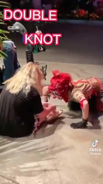 A clowns giving a nice shoe tying lesson