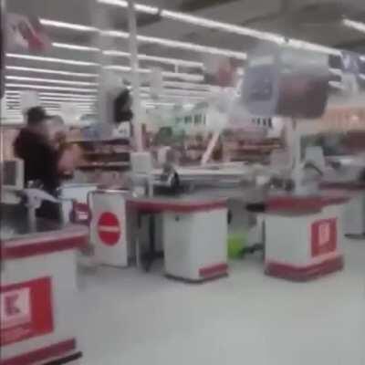 Drunk guy hiding from cops at a check out stand