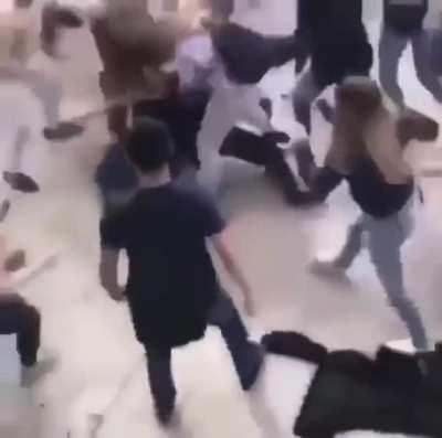 Guy gets jumped when he punches the wrong girl.