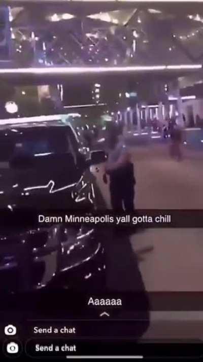 Minneapolis police officer falls to the ground after a rioter throws a heavy object at his head.