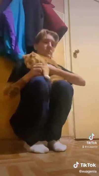 Local girl is hiding in the corridor with her cat while russian rockets hit an apartment building nearby (Zaporizhzhia, October 09, 2022)