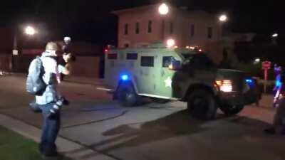 Kenosha, WI. Rioters block armored police vehicle while some are armed with rifles. Possible shots fired at the vehicle.
