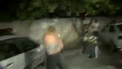 Trying to break policeman's window