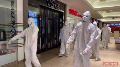 Masked people dressed in white storms a Toronto mall to protest COVID vaccines 😷