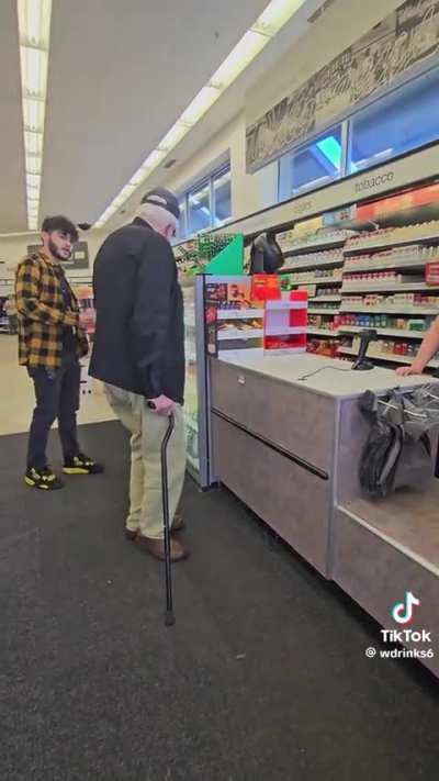 Guy stands on business in Walgreens