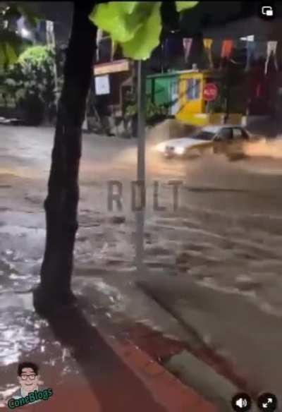 Trying to drive across a flooded road