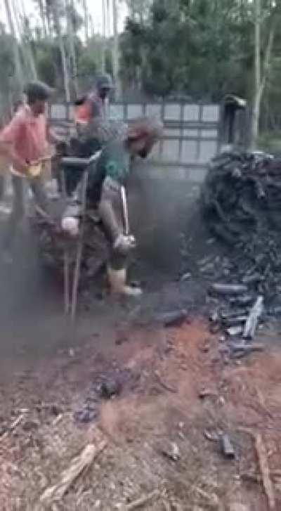 This amputee using his crutch to help him clear fire damage.