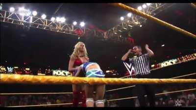 Charlotte focuses her assault on Alexa’s stomach and back. She manages to sneak in an illegal choke on the middle ropes too!