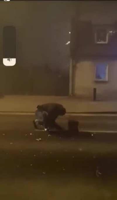 Firing off fireworks in the middle of a foggy street