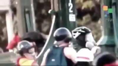 The exact moment when a policeman pushes a sixteen year old boy off a bridge. Santiago de Chile.