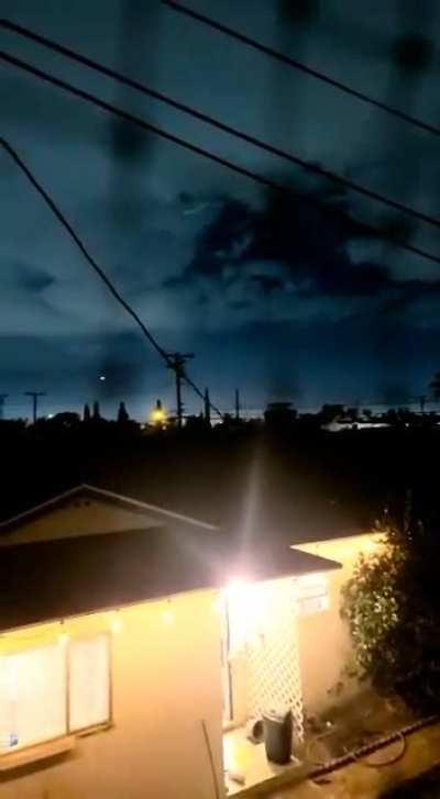 UFO during lighting strike in CA; starts by swooping in through the middle then escapes