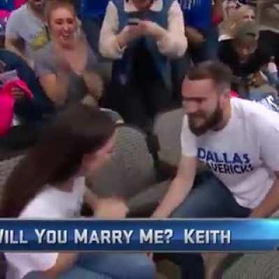 Guy in background steals show during proposal