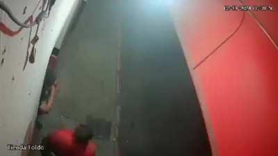 Crashing car barely misses a pair of men standing at the door