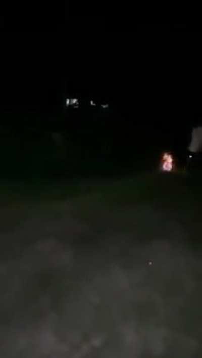 Guys lighting up a soccer ball and passing it around